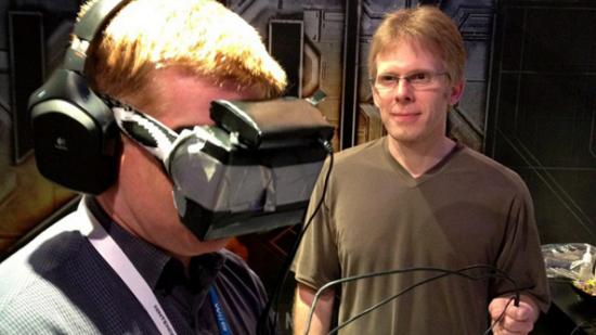 John Carmack stands next to a person wearing an Oculus Rift.