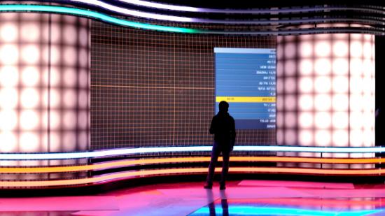 A lone figure on a glossy stage stands in silhouette against the neon backdrop while a test screen menu is displayed on the screen.