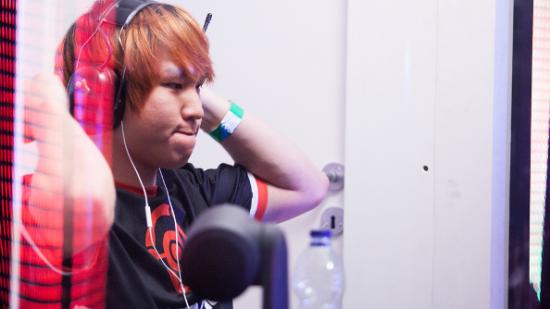 Flame-haired professional gamer Hyun removes his headset in the booth following a victory at DreamHack Valencia.