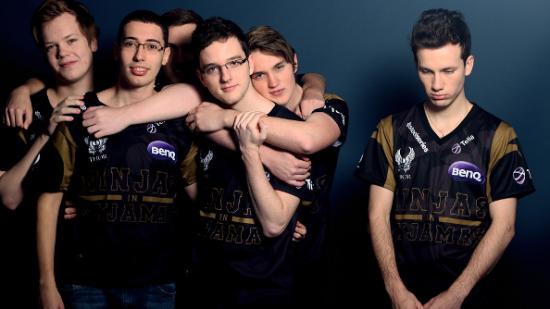Five members of the Ninjas in Pyjamas team huddle happily to the left side in their black and gold jerseys, while a lone member stands sadly alone on the right, eyes downcast.
