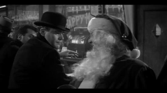 A still from "The Apartment" with Jack Lemmon. In black and white, Lemmon glowers at a drunk Santa in a seedy bar.