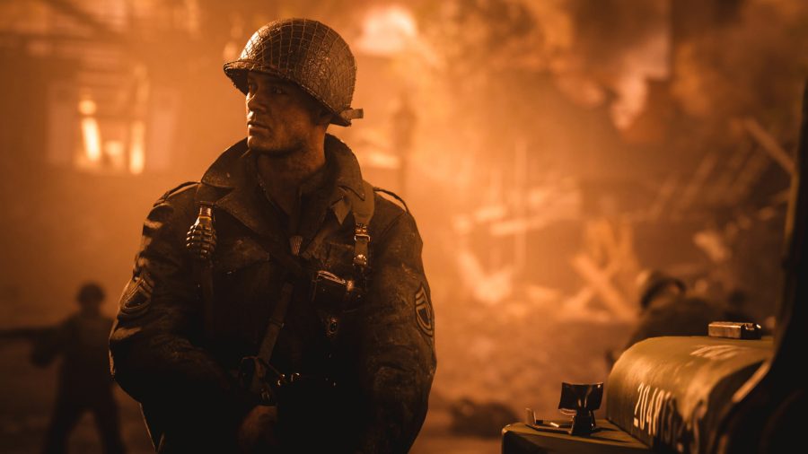 Pierson looking away from a burning building in Call of Duty WWII