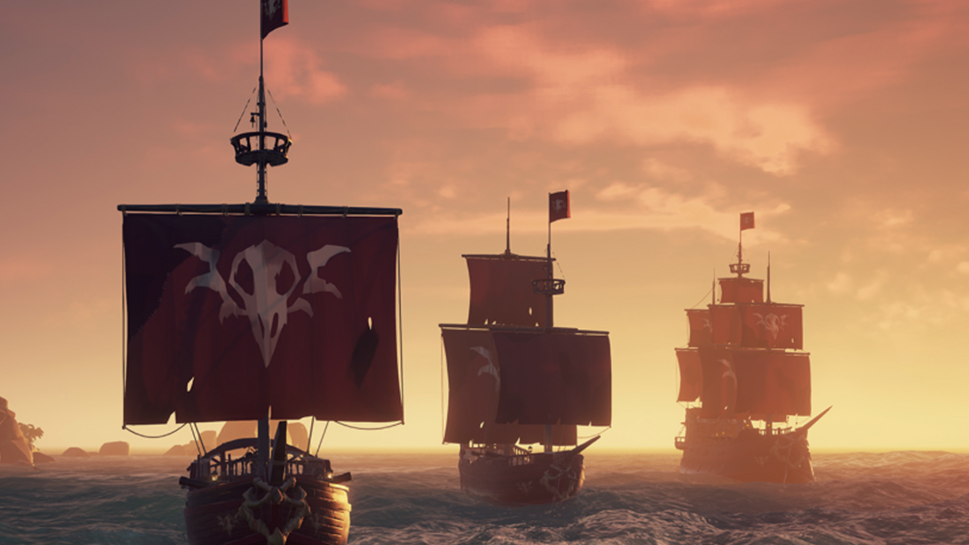 Best Pirate games: Three ships sailing into the sunset in Sea of Thieves.