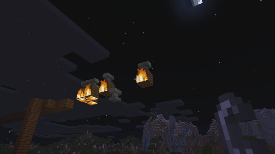 Minecraft anvils placed on top of wooden blocks that are burning. When the anvils fall, they dead damage based on how high up they are.