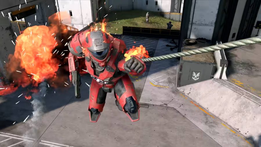 A Spartan is on fire while using the grappleshot in Halo Infinite.