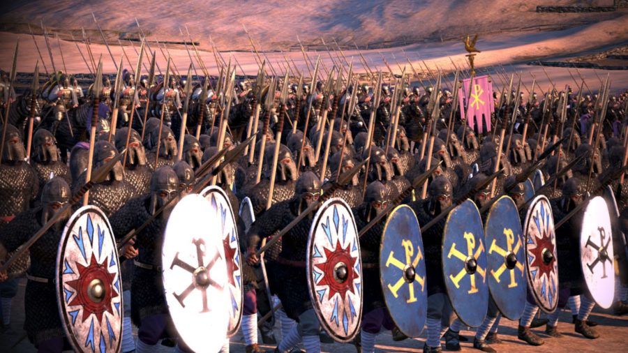 A large army of spearmen. The frontline are holdings shields in a formation.