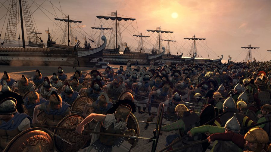 Two armies are fighting on a beach. Several ships are docked in the background.