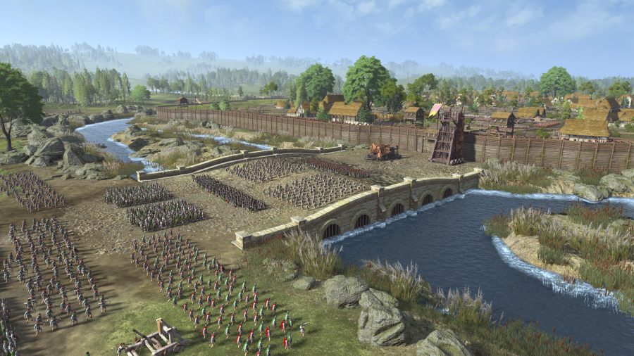 A massive army has appeared on the bridge close to a town. The town has flimsy wooden walls that are easily overcome by siege towers. A battering ram is being set up at the base of the wall.