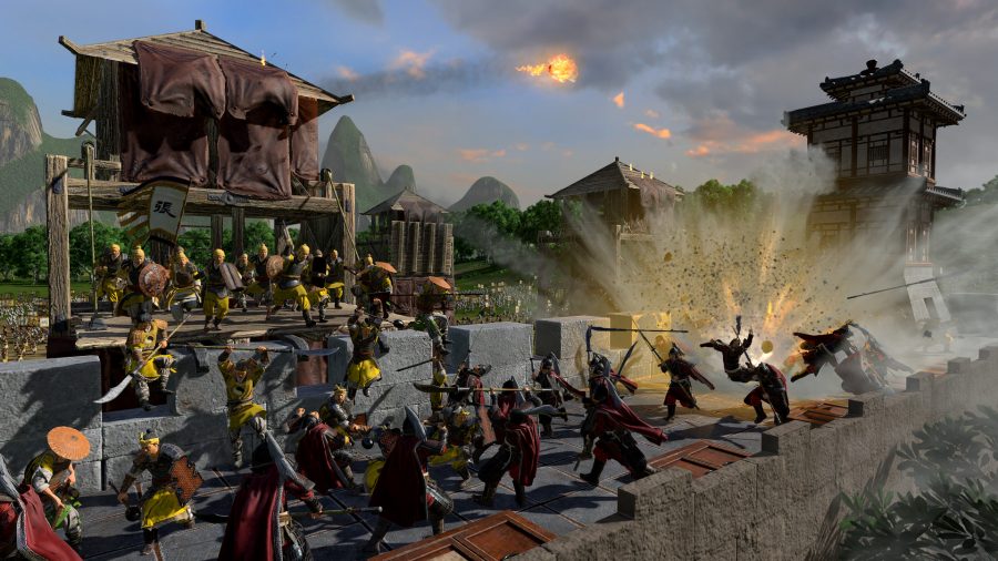 Troops in red are scaling the walls of a fort that is being defended by yellow. A big melee is happening on the wall, just as a cannonball blasts the right-hand side.