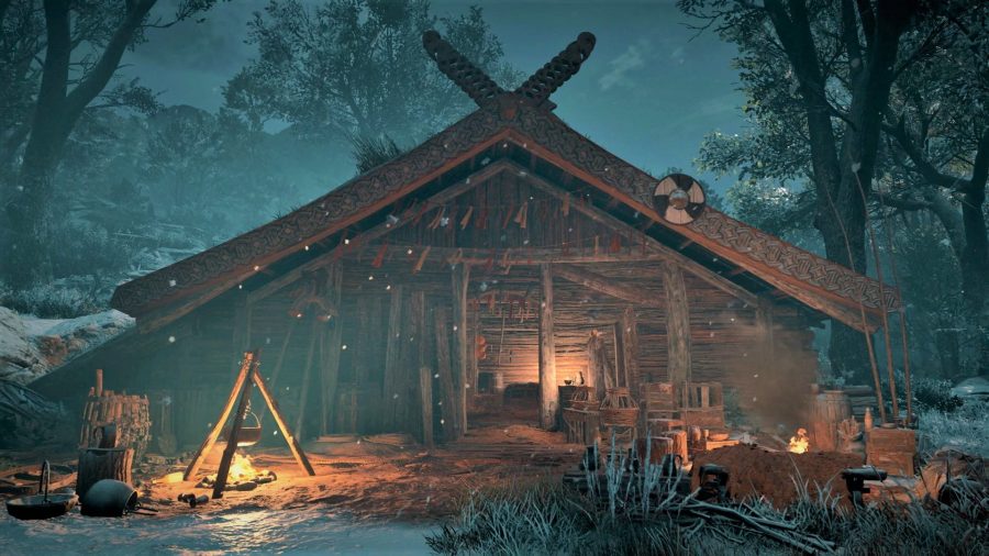A log cabin in Assassins Creed Valhalla at the time of the Yule festival. There is a fire going with a pot suspended above it.