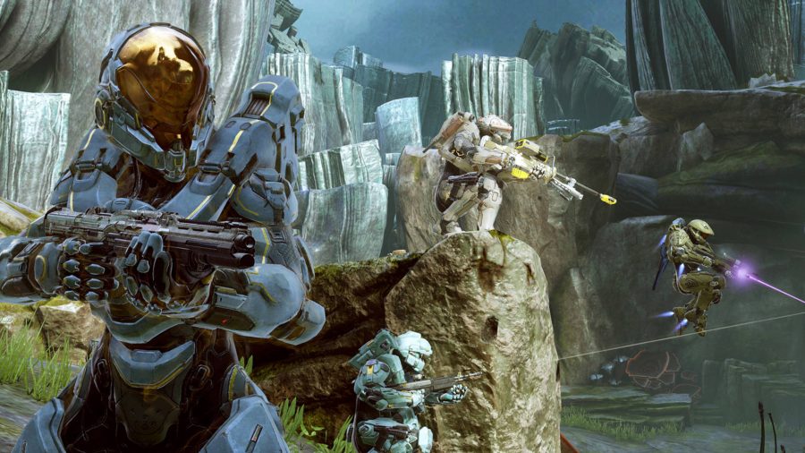 Several Spartan warriors firing their guns at an offscreen enemy in Halo 5: Guardians, one of the console games we wish were on PC. 