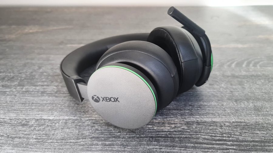 Microsoft's Xbox Wireless Headset lay down on a grey desk with the logo prominently on display