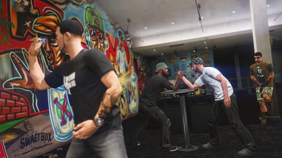 GTA Online players arm wrestling inside a clubhouse from the Bikers update