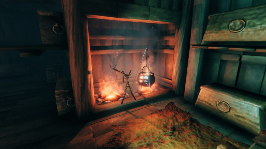 A cauldron and cooking station over a fire pit in Valheim
