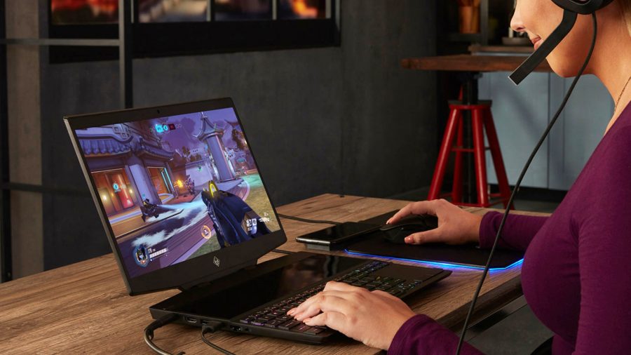 A woman plays games using the Omen X 2S 15 gaming laptop
