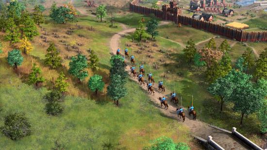 A column of mounted units approach a walled town