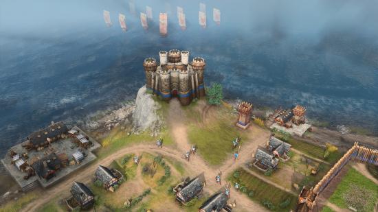 A keep on a hill looking out over the sea in age of empires 4 as a fleet of ship approaches