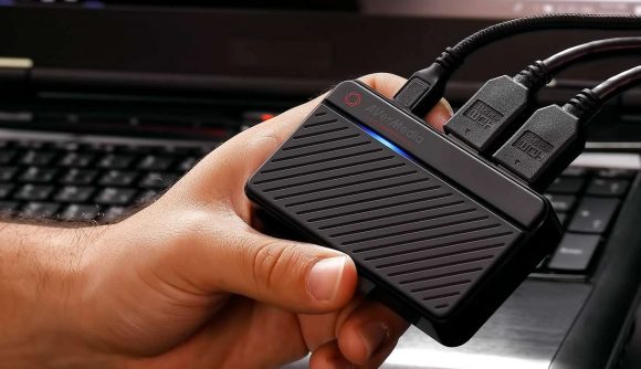Pocket-sized Avermedia capture card in someone's hand