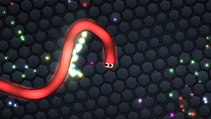 A red worm from Sliter.io, one of the best io games, collecting the shiny pellets littered on the battlefield