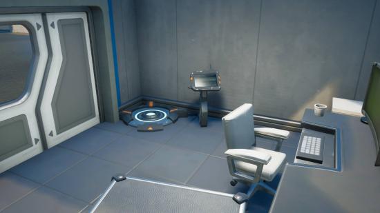 One of the Fortnite body scanners. It is a circular platform with a console attached to it.