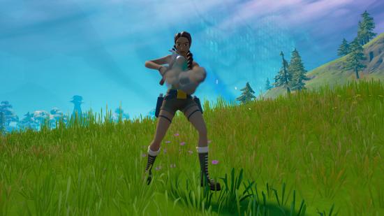 Lara is using a hammer to craft a new weapon in Fortnite.