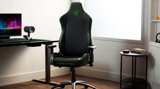 Black and green gaming chair in front of a gaming setup