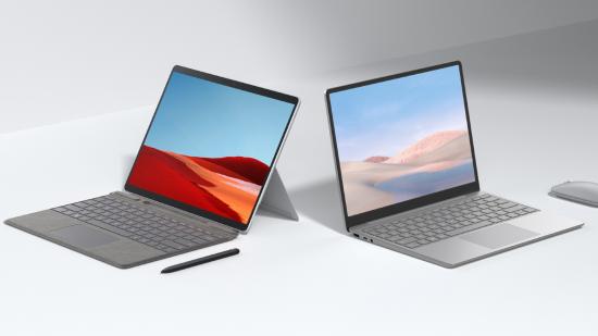 Two Windows-based laptops, one with a propped up screen and a pen