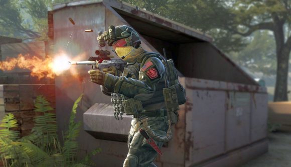 A CSGO character in armour firing a rifle in a forested street