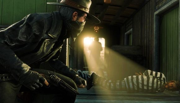 A Red Dead Online player looks towards a criminal in jail