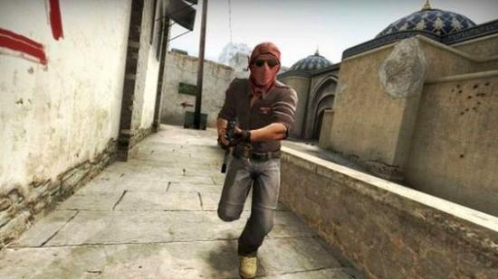 A CS:GO character running at the camera with a rifle in the Mirage map