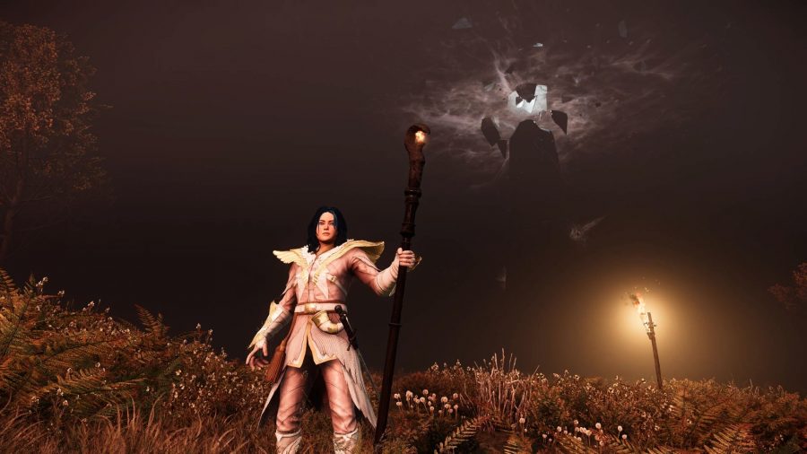 Standing against a dark sky with the fire staff in New World