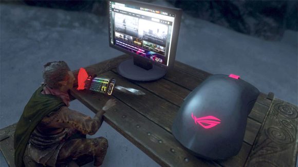 Skyrim's protagonist sits at a gaming PC, placing their Asus ROG-branded staff that looks like a keyboard and a mouse-shaped shield on the desk