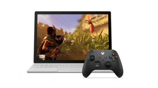 Gaming laptop with black xbox controller on white background