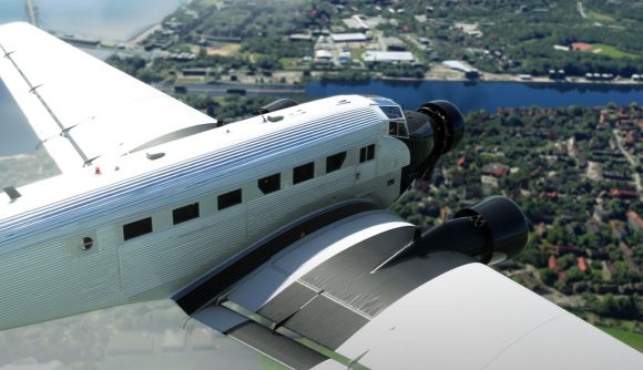 Microsoft Flight Simulator's Junkers JU-52 craft flying above fields and villages