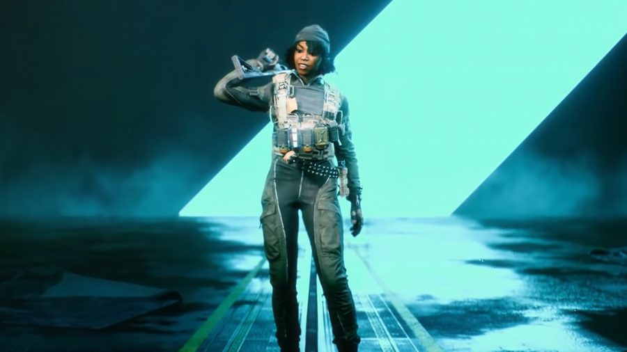 Emma 'Sundance' Rosier, the assault specialist, standing in front of a bright blue line in a dark room