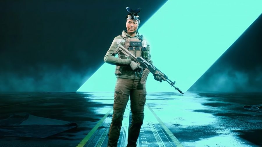 Ji-Soo Paik, the recon specialist, standing in front of a bright blue line in a dark room