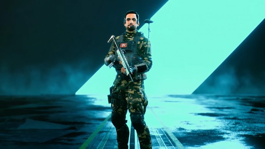 Navin Rao, the recon specialist, standing in front of a bright blue line in a dark room