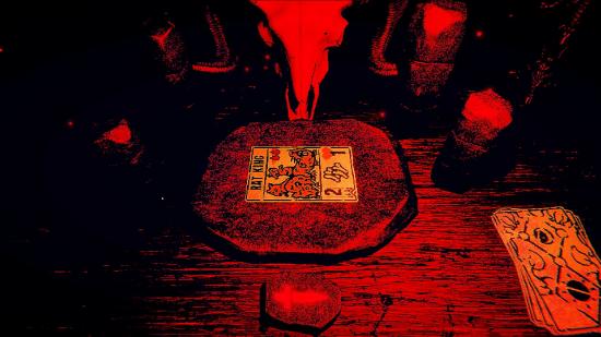 A red and black table with a ram skull overlooking it, with a 'Rat King' tarot card in the table's centre