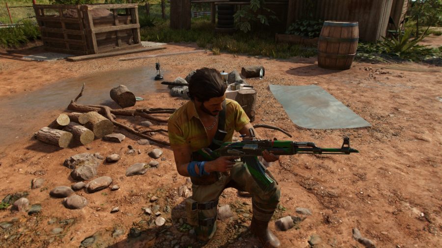 A man fiddling with a gun in open world game Far Cry 6