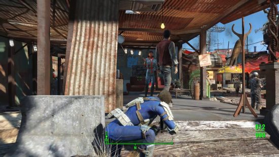 Best Fallout 4 mods: The sole survivor of Fallout 4 crouches behind a concrete slab and peeks out at two NPCs conversing