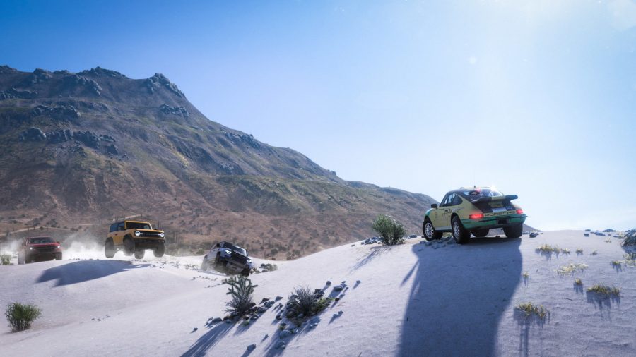 A screenshot from Forza Horizon 5, featuring several cars atop a glistening snowtop