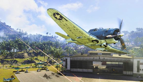 A plane is flying close to a hangar, being shot at by an AA gun in the Caldera map in Warzone.