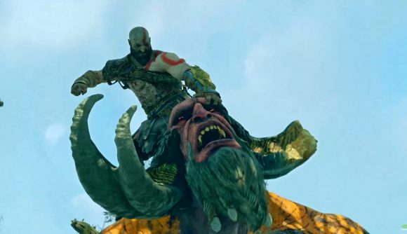 Kratos attacks a troll while perched atop its head in God of War.