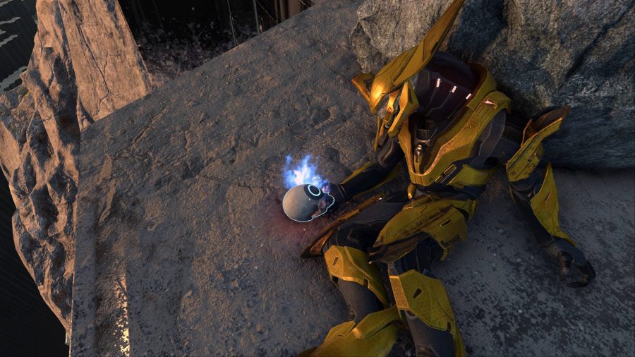 One of the collectible skulls in Halo Infinite in the hands of an Elite.