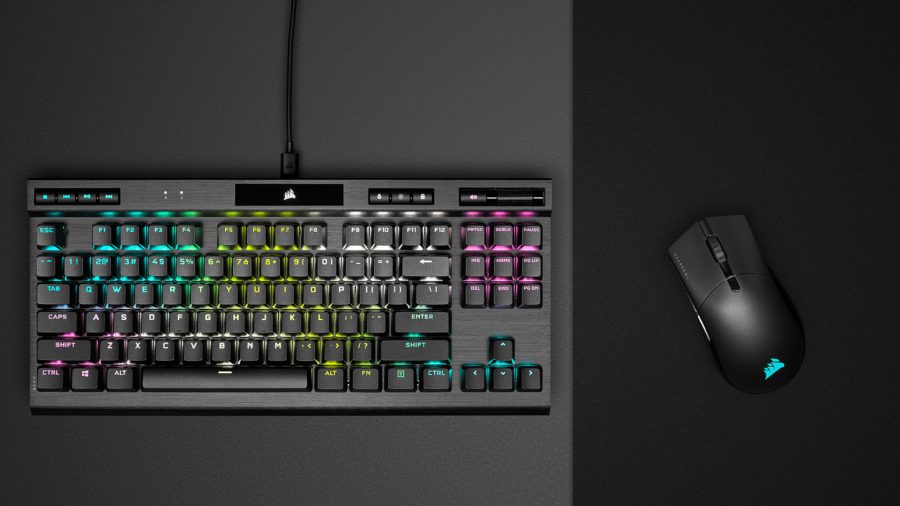 The Corsair Sabre RGB Pro Wireless gaming mouse next to a Corsair gaming keyboard