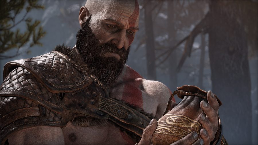 Kratos mournfully gazes at the pouch containing his lover's ashes