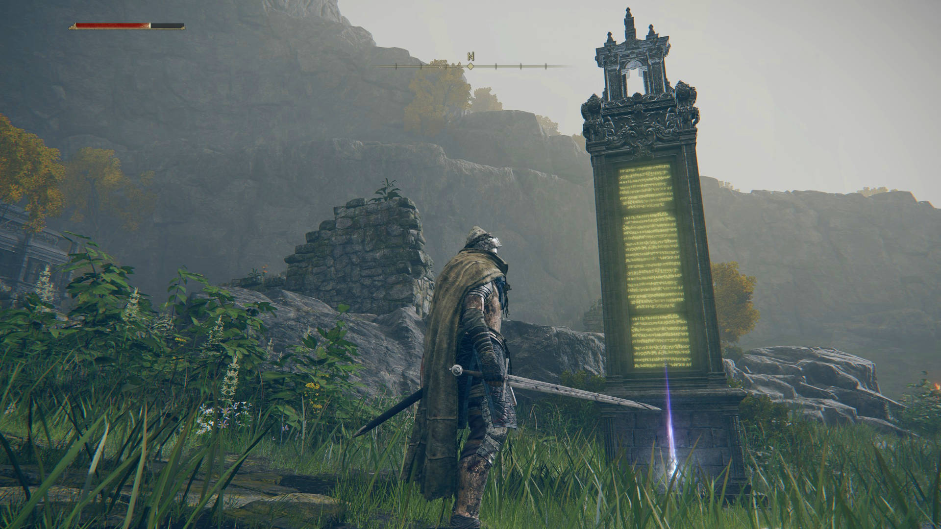 Elden Ring map fragments - a Tarnished is standing next to a monument with glowing yellow text. A map fragment is on the ground, highlighted by a purple light.