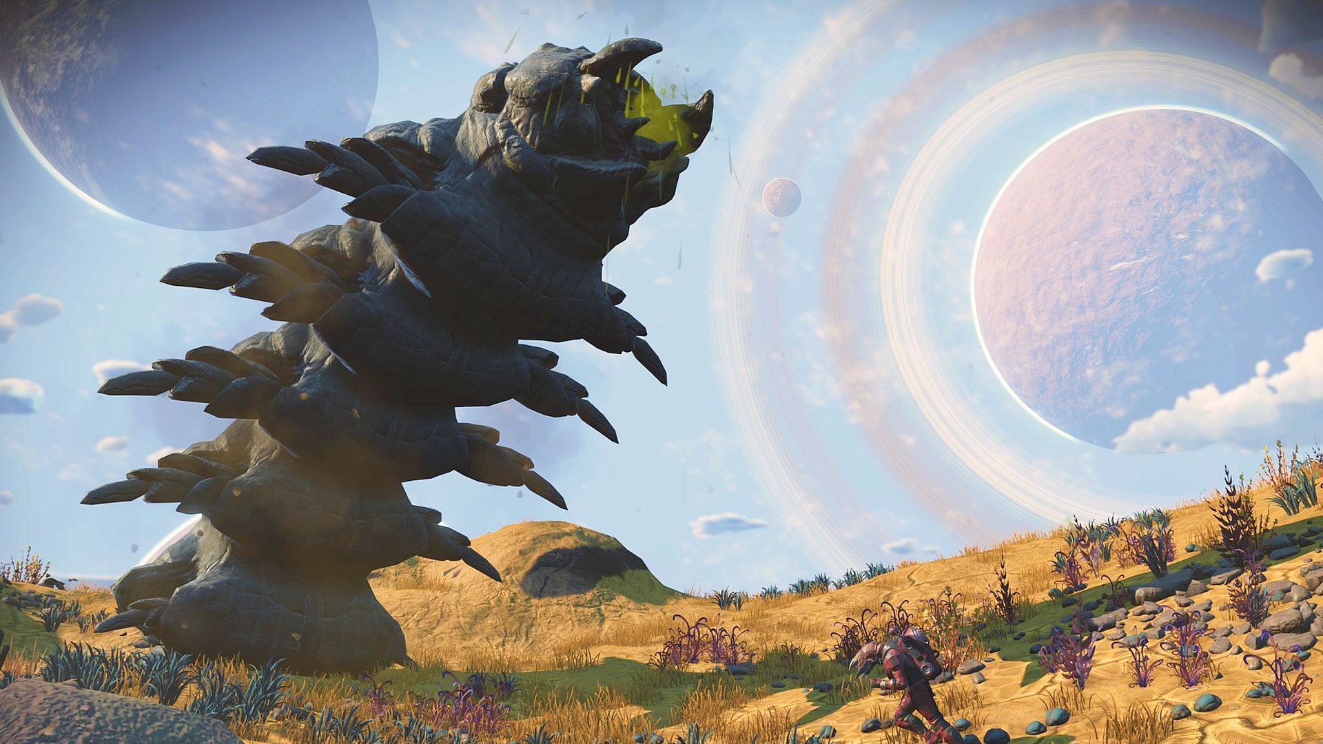 A giant centipede alien emerging from a planet's surface in No Man's Sky