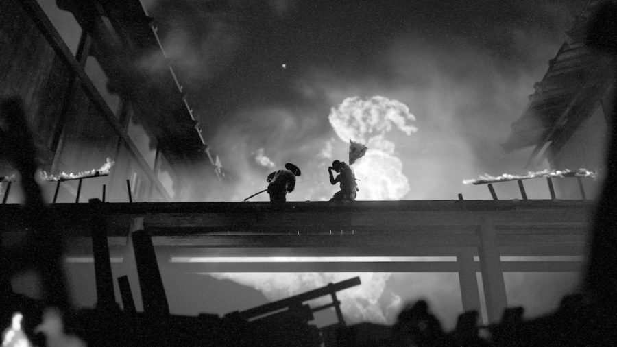 A grainy, black and white screenshot showing two warriors battling with katanas while a village burns in the background