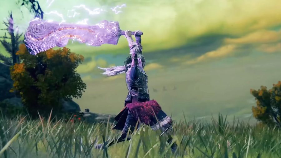 An Elden Ring character standing on grass as they power up a great sword using purple energy